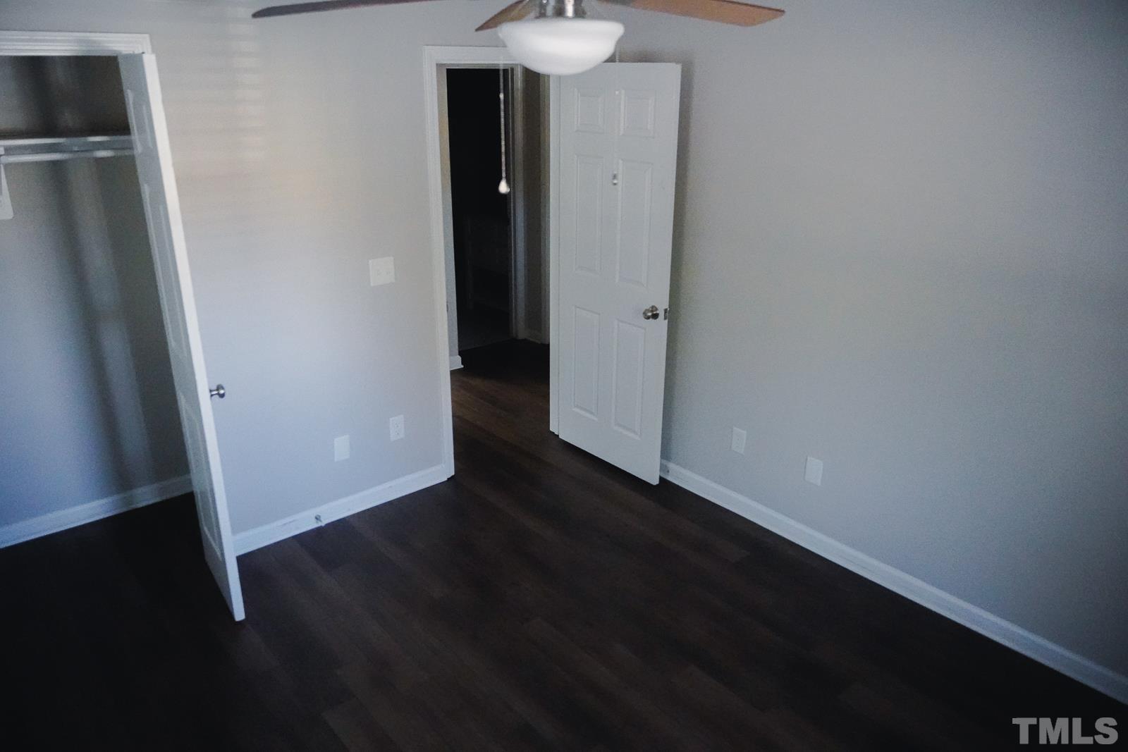 1320 South State Street, Unit A Raleigh, NC 27610 - Photo 10 of 20 a view of an empty room with wooden floor and a sink