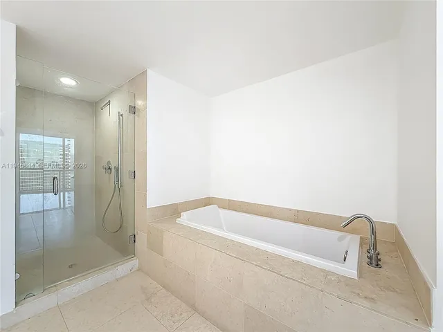 a bathroom with a bathtub and shower
