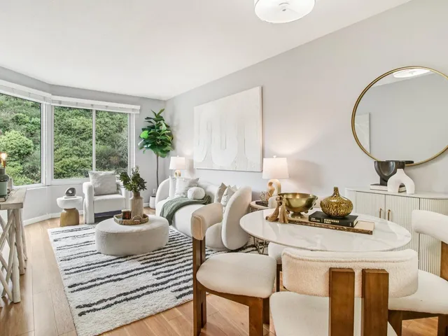 a living room with furniture and a mirror