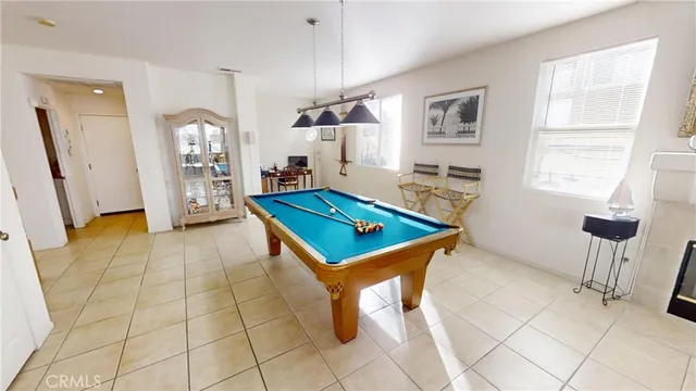 a room with pool table and windows