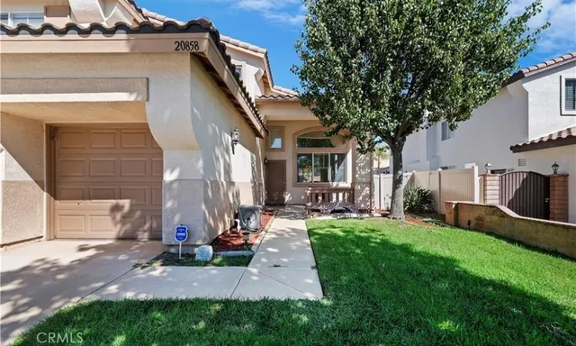 a view of backyard of house with outdoor seating and green space