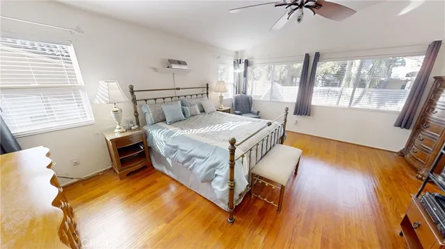 a bedroom with a bed and a table with the outer view