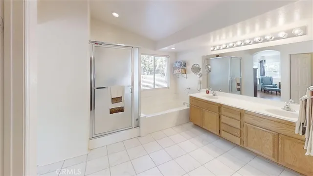 a bathroom with a tub sink and mirror