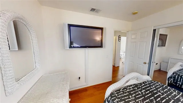 a bed sitting in a bedroom next to a window