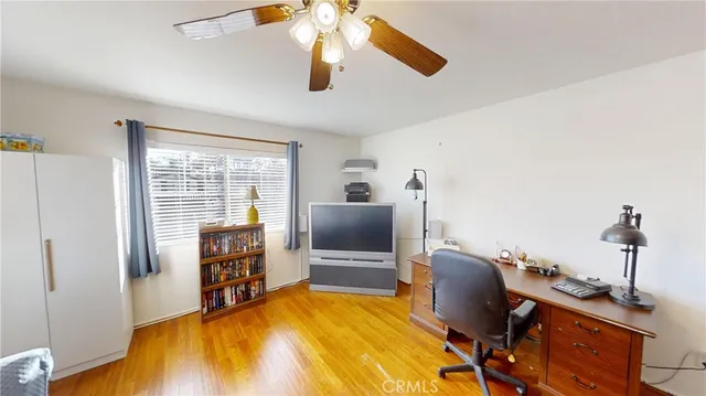 a living room with furniture and a kitchen