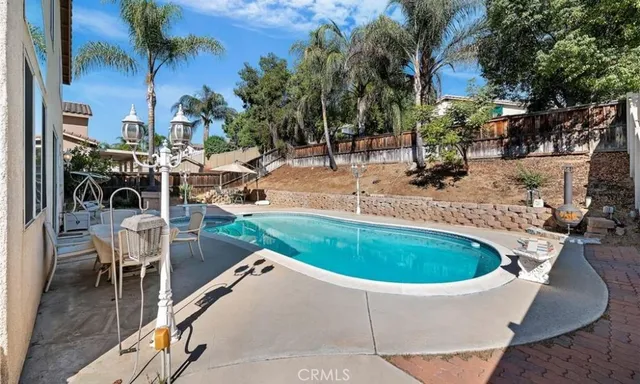 a view of a backyard with a patio and a fire pit
