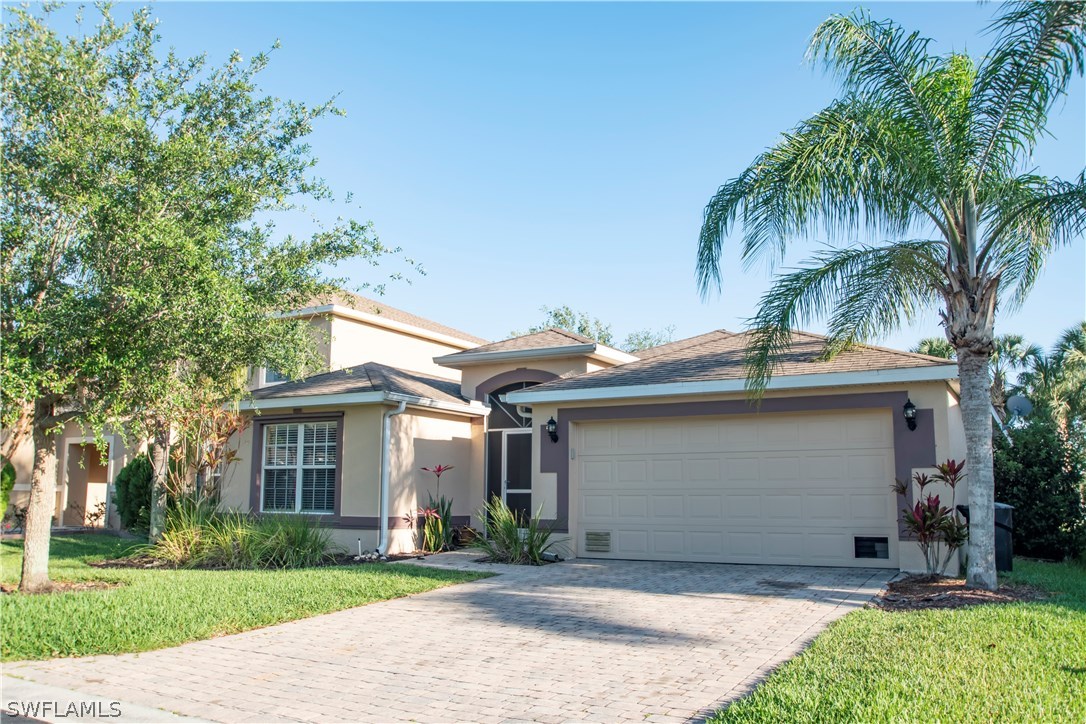 8879 Falcon Pointe Loop Fort Myers, FL 33912 - Photo 1 of 17 front view of a house with a yard