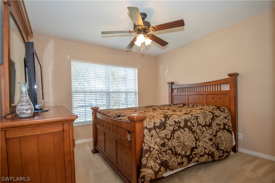 8879 Falcon Pointe Loop Fort Myers, FL 33912 - Photo 11 of 17 a bedroom with a bed and window