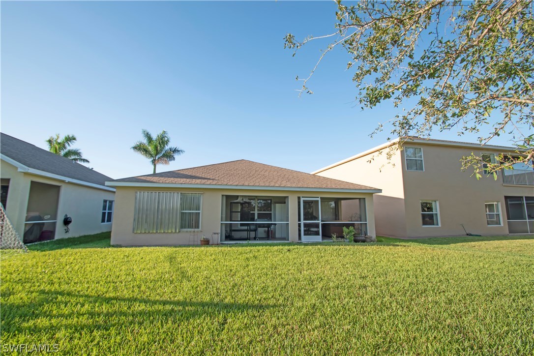 8879 Falcon Pointe Loop Fort Myers, FL 33912 - Photo 16 of 17 a view of a house with a backyard