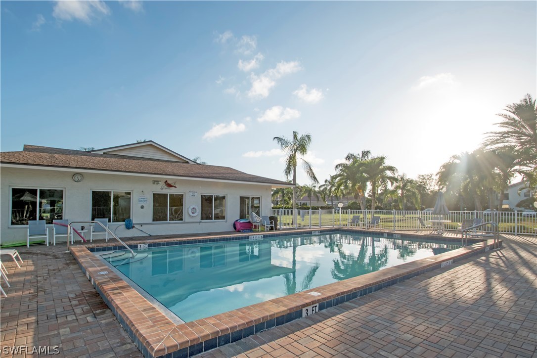 8879 Falcon Pointe Loop Fort Myers, FL 33912 - Photo 17 of 17 a view of a house with large pool and a yard