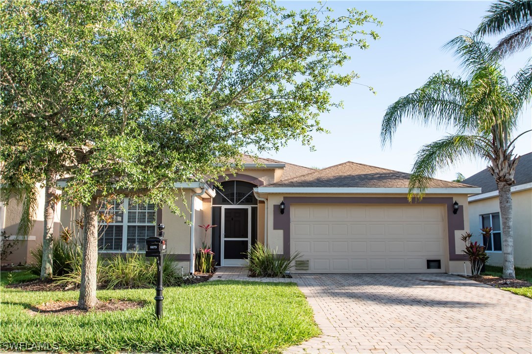 8879 Falcon Pointe Loop Fort Myers, FL 33912 - Photo 2 of 17 front view of a house with a yard