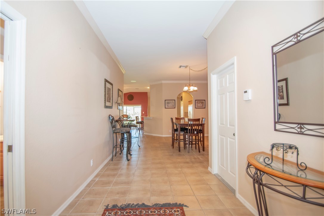 8879 Falcon Pointe Loop Fort Myers, FL 33912 - Photo 3 of 17 a dining room with furniture and a mirror