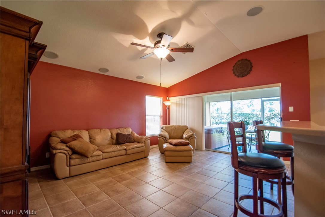 8879 Falcon Pointe Loop Fort Myers, FL 33912 - Photo 4 of 17 a living room with furniture a fireplace and a large window