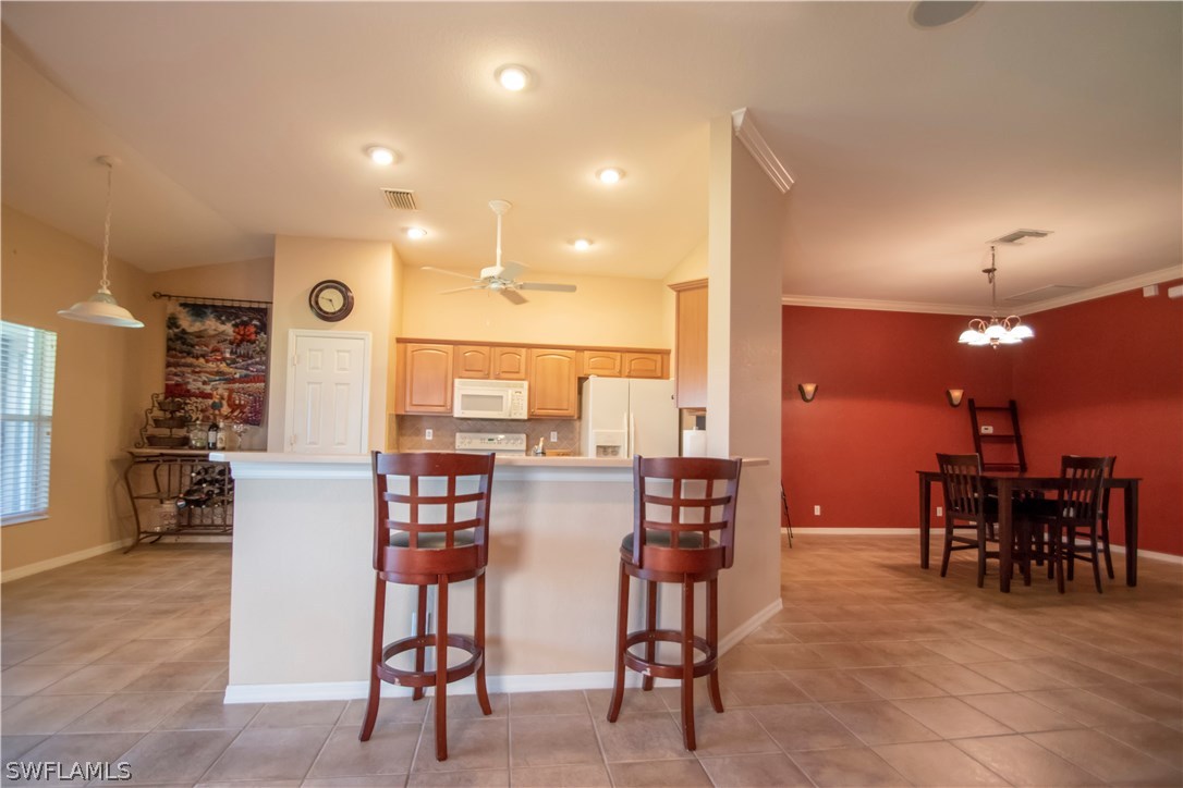 8879 Falcon Pointe Loop Fort Myers, FL 33912 - Photo 5 of 17 a view of a dining room with furniture