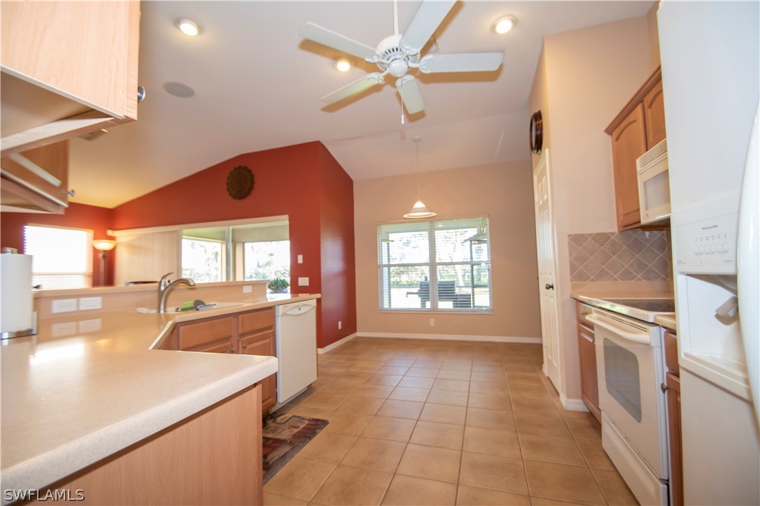 8879 Falcon Pointe Loop Fort Myers, FL 33912 - Photo 8 of 17 a kitchen with a sink appliances and cabinets