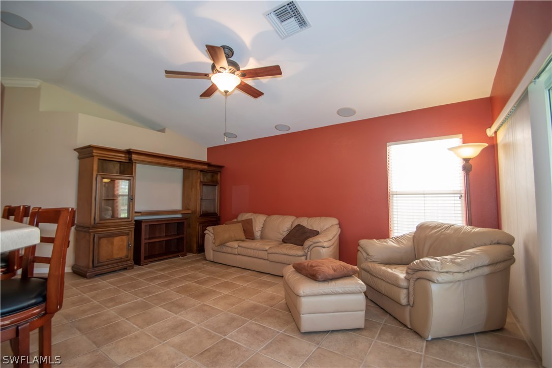 8879 Falcon Pointe Loop Fort Myers, FL 33912 - Photo 9 of 17 a living room with furniture ceiling fan and a window