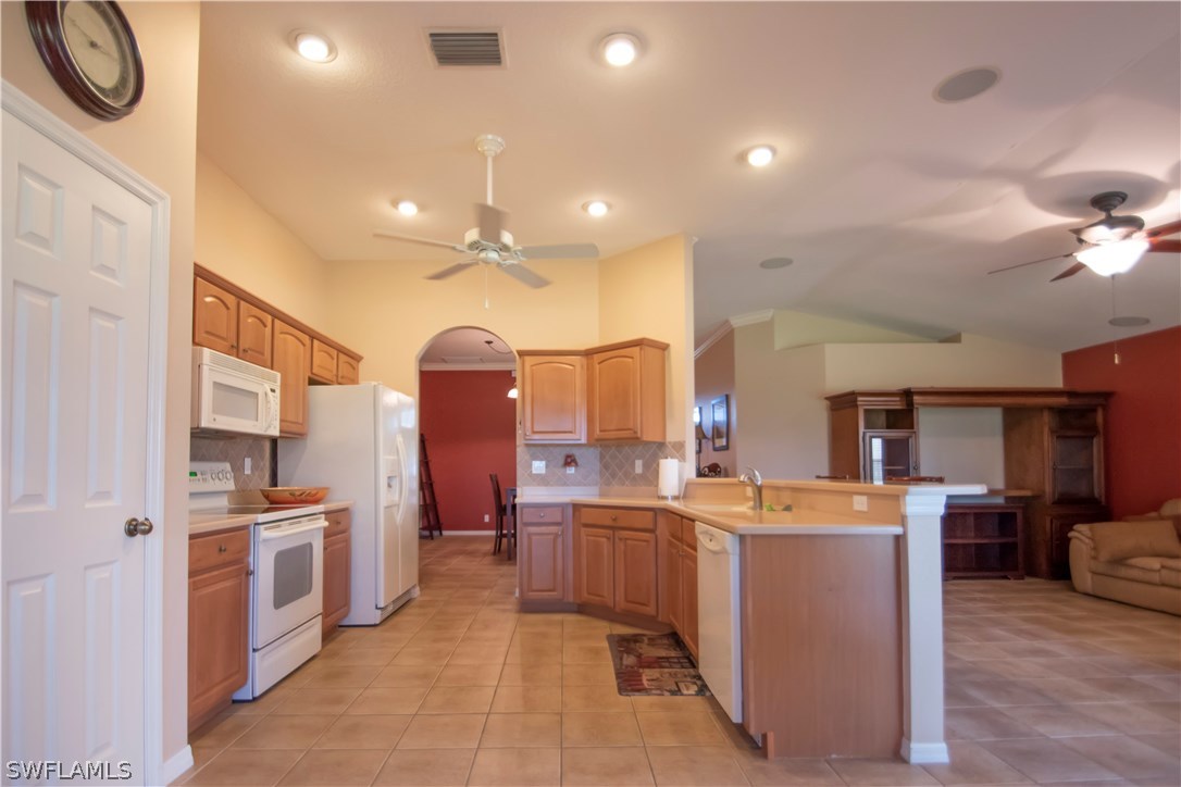 8879 Falcon Pointe Loop Fort Myers, FL 33912 - Photo 10 of 17 a kitchen with cabinets a sink and appliances