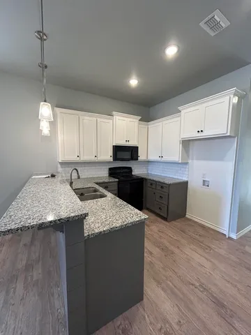 a kitchen with stainless steel appliances granite countertop wooden cabinets a sink and dishwasher