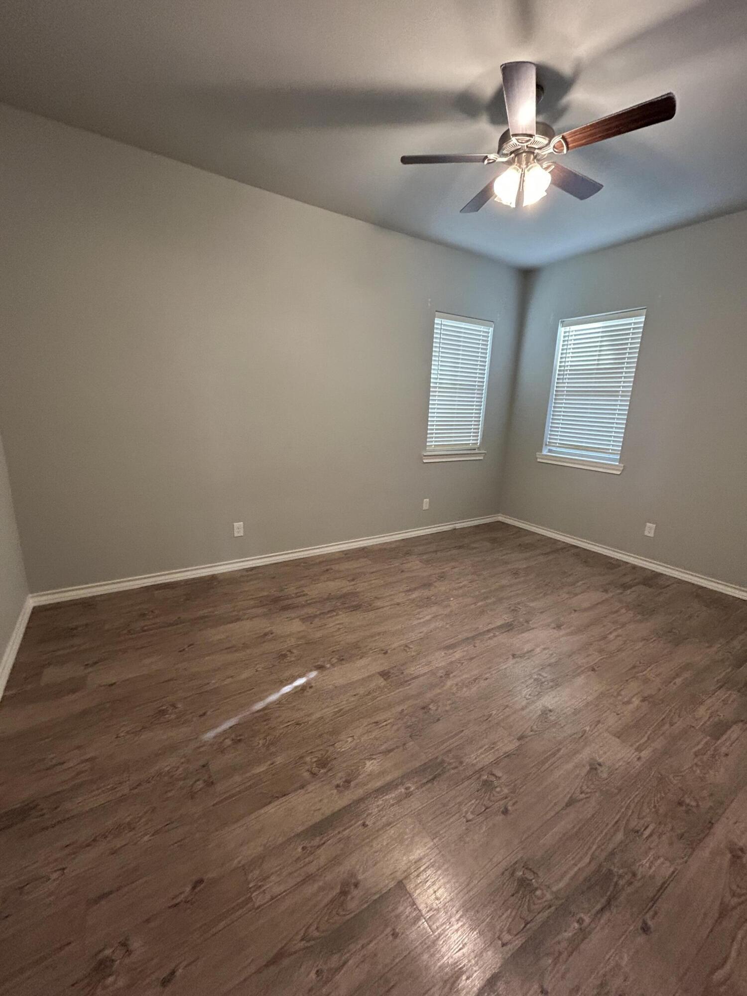 4717 121st Place Lubbock, TX 79424 - Photo 8 of 10 wooden floor in an empty room with a window