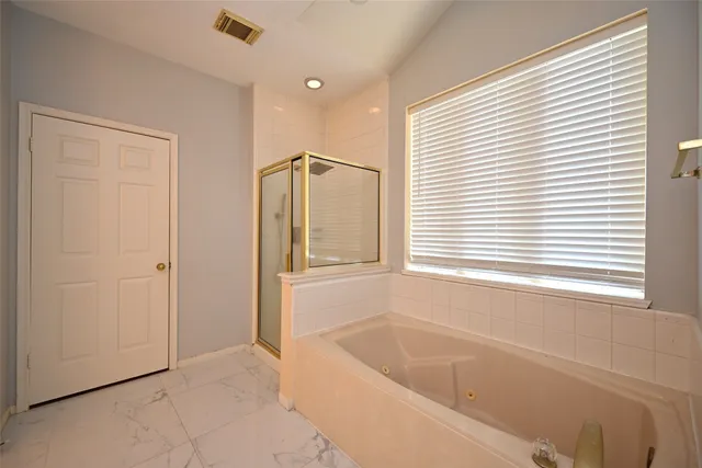 a bathroom with a bathtub and window
