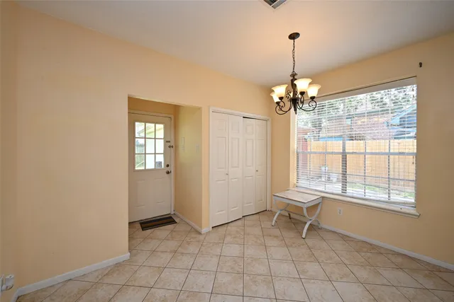 a living room with a window and a table