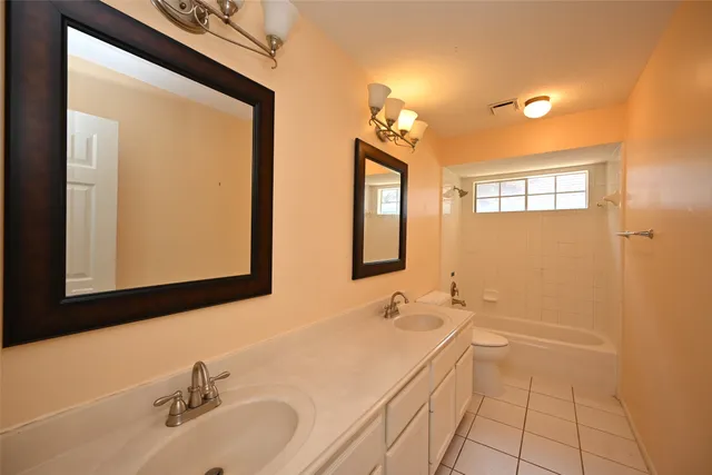 a bathroom with a double vanity sink a mirror and a