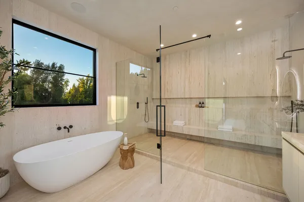 a bathroom with a bathtub and a shower