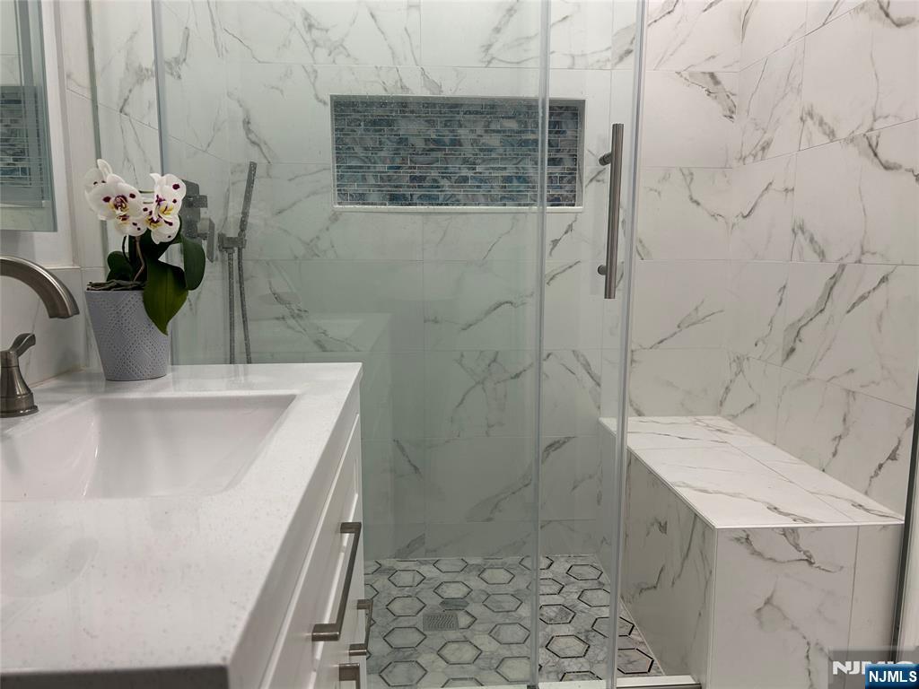 111 Teaneck Road Teaneck, NJ 07666 - Photo 11 of 22 a bathroom with a sink a toilet and shower