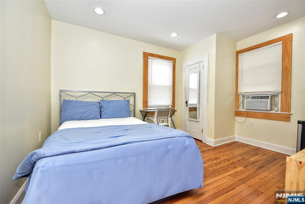 111 Teaneck Road Teaneck, NJ 07666 - Photo 12 of 22 a bedroom with a large bed and wooden floor