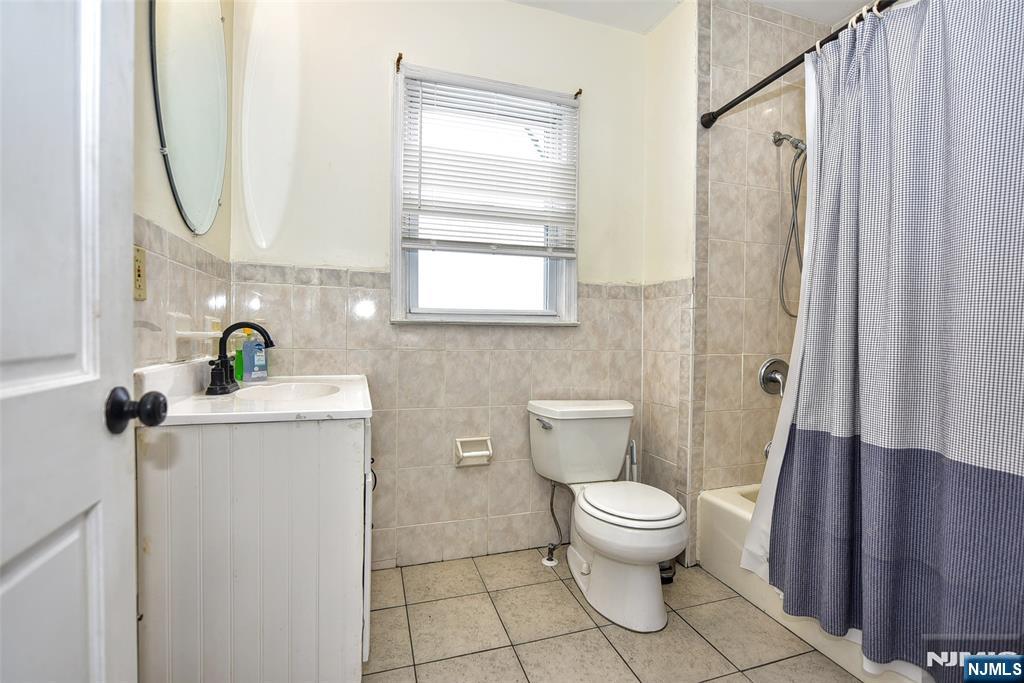 111 Teaneck Road Teaneck, NJ 07666 - Photo 13 of 22 a bathroom with a toilet sink and mirror