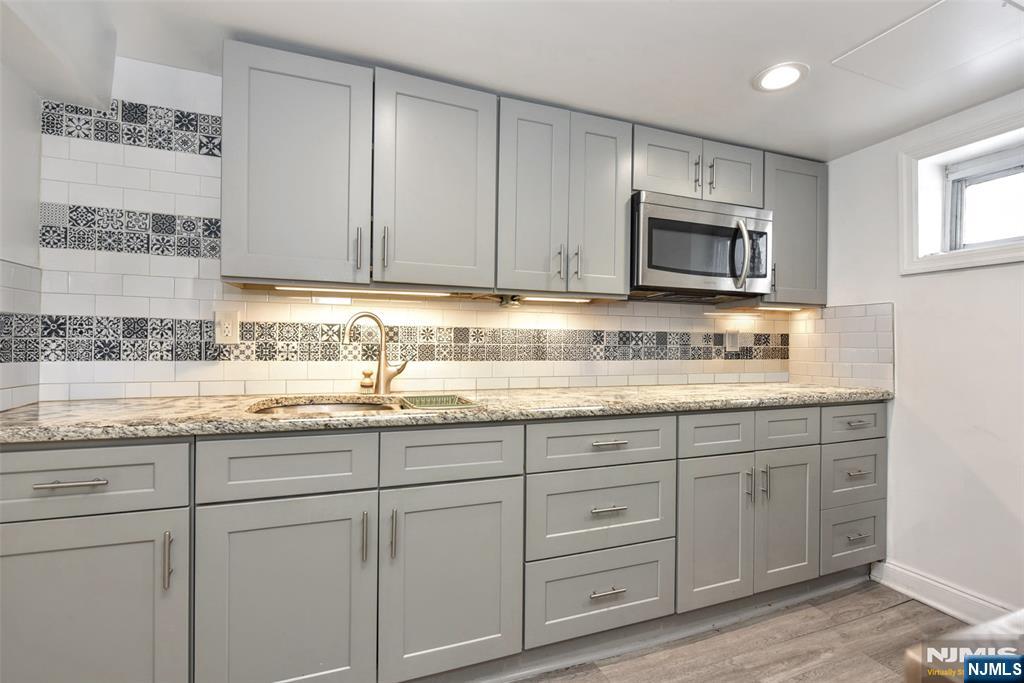 111 Teaneck Road Teaneck, NJ 07666 - Photo 16 of 22 a kitchen with granite countertop cabinets stainless steel appliances and a sink