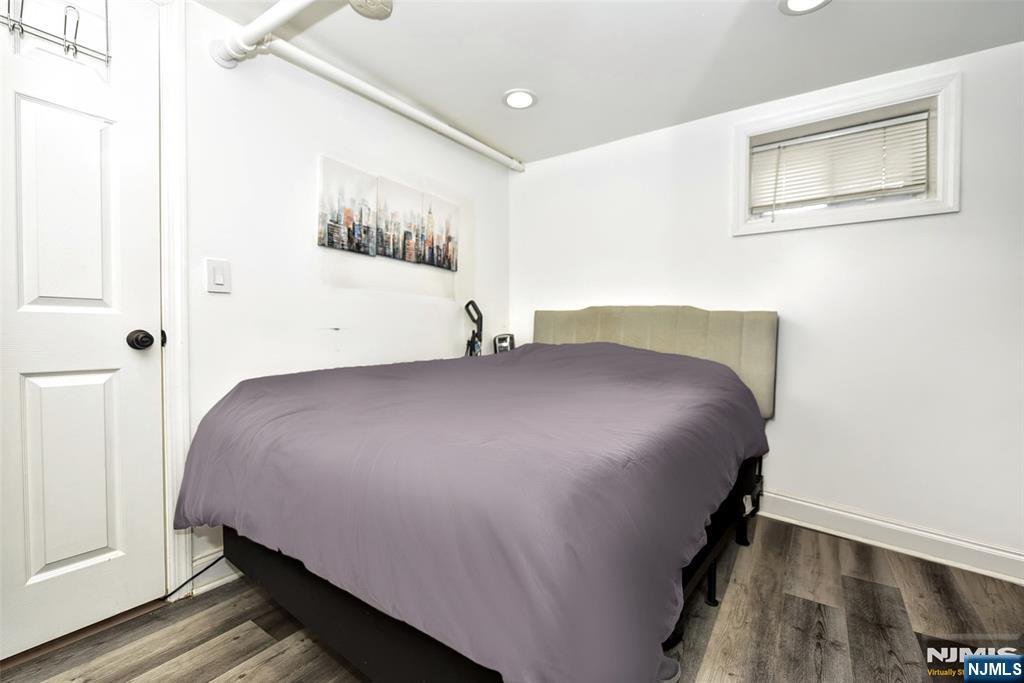 111 Teaneck Road Teaneck, NJ 07666 - Photo 17 of 22 a bedroom with a bed and wall painting