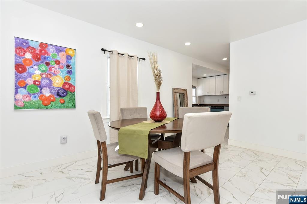 111 Teaneck Road Teaneck, NJ 07666 - Photo 6 of 22 a dining room with furniture and a kitchen view