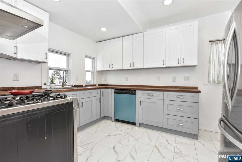 111 Teaneck Road Teaneck, NJ 07666 - Photo 7 of 22 a kitchen with cabinets appliances and a window