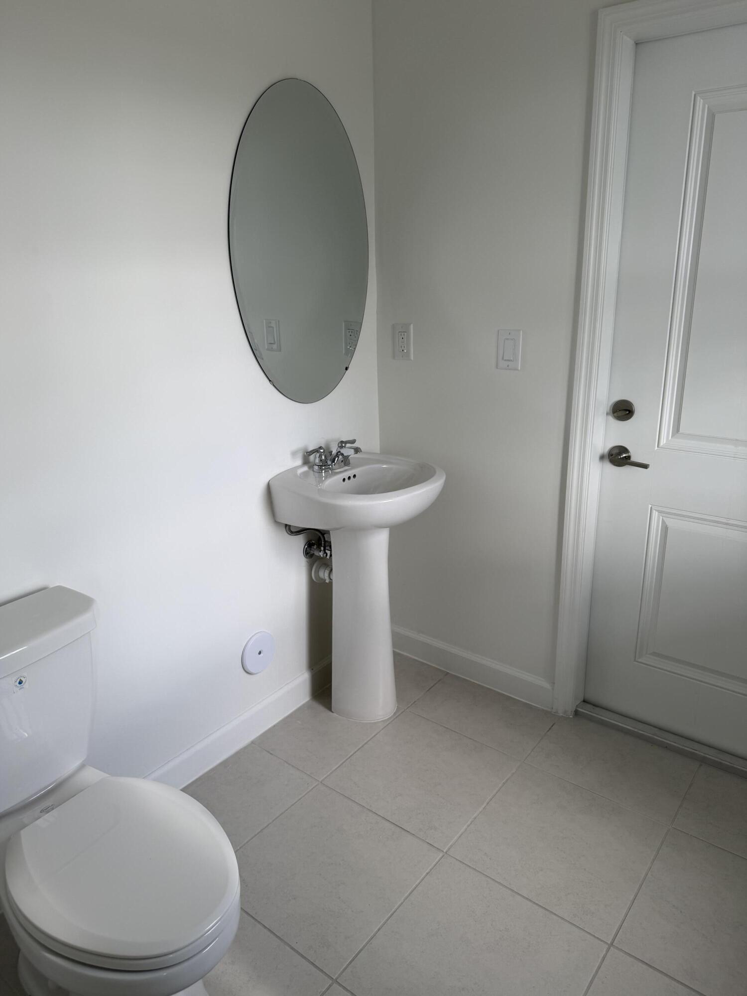 19407 Southwest 340th Street Homestead, FL 33034 - Photo 14 of 15 a bathroom with a sink toilet and a mirror