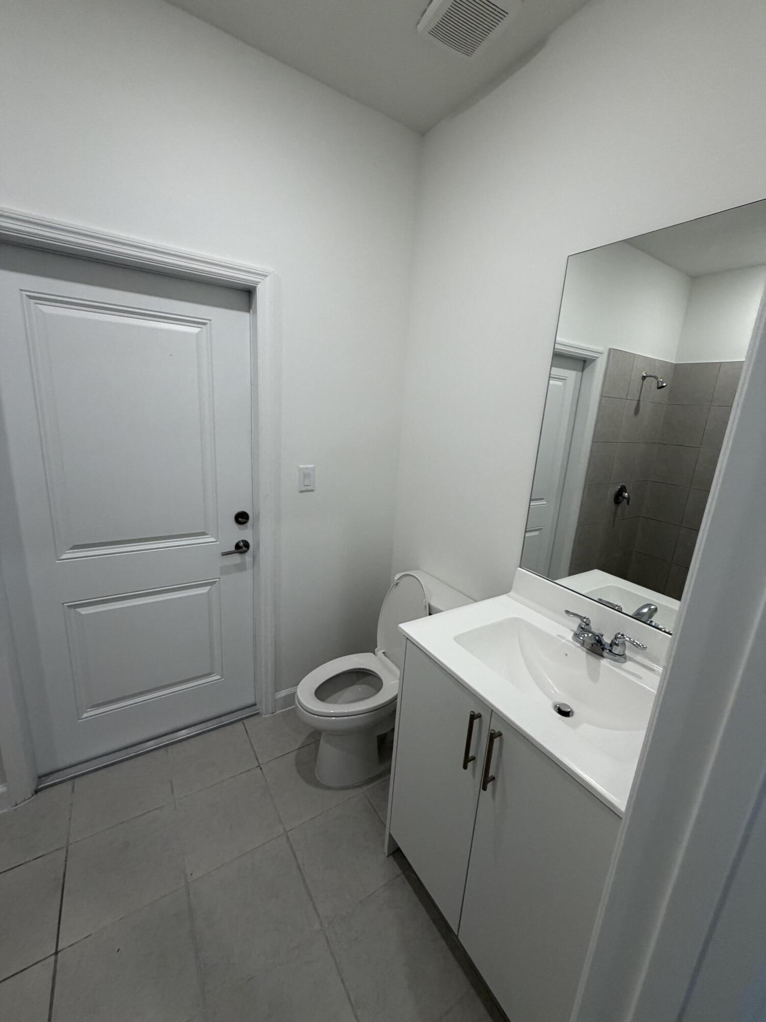 19407 Southwest 340th Street Homestead, FL 33034 - Photo 15 of 15 a bathroom with a sink a toilet and mirror