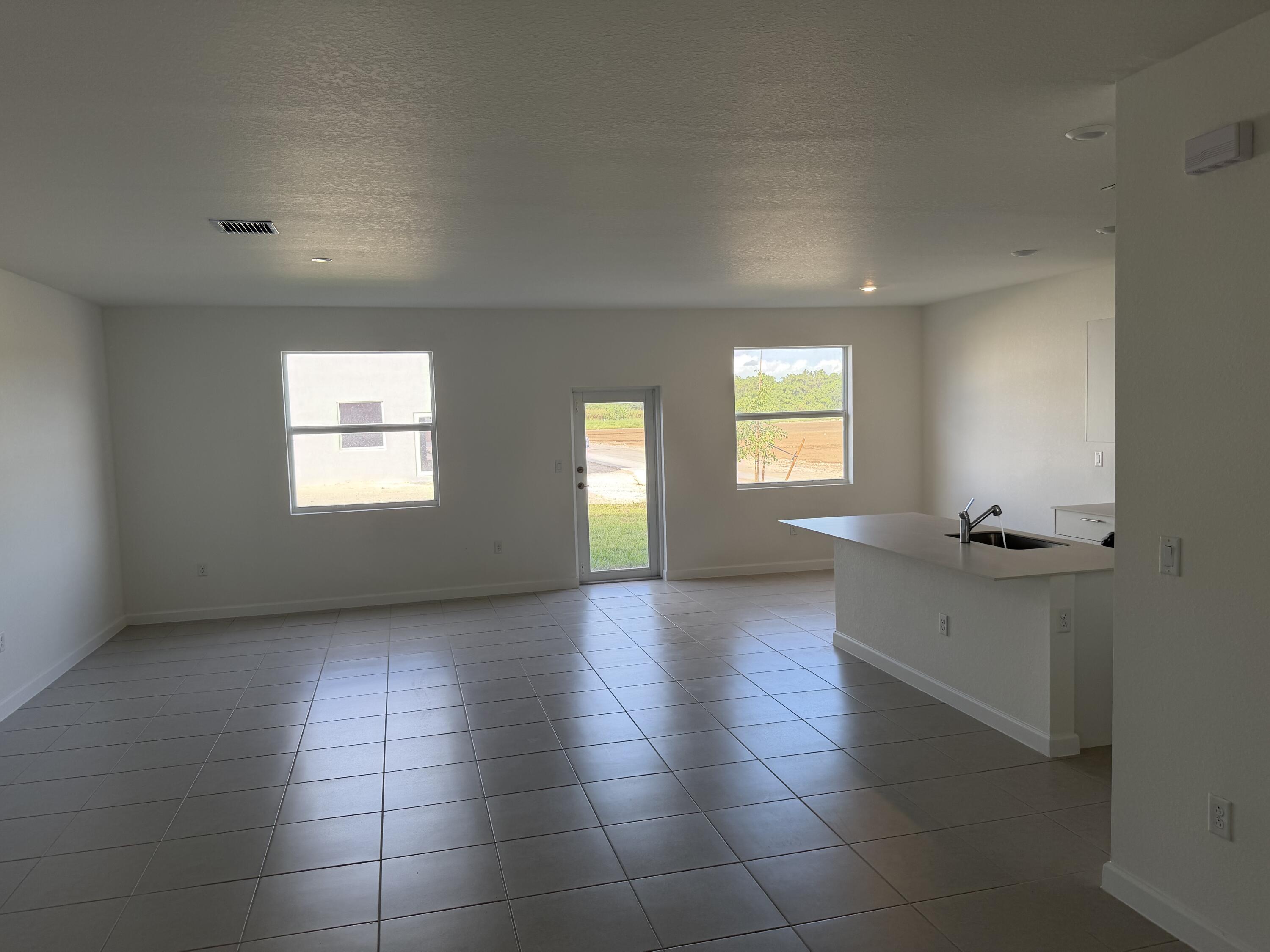 19407 Southwest 340th Street Homestead, FL 33034 - Photo 6 of 15 a view of an empty room and window