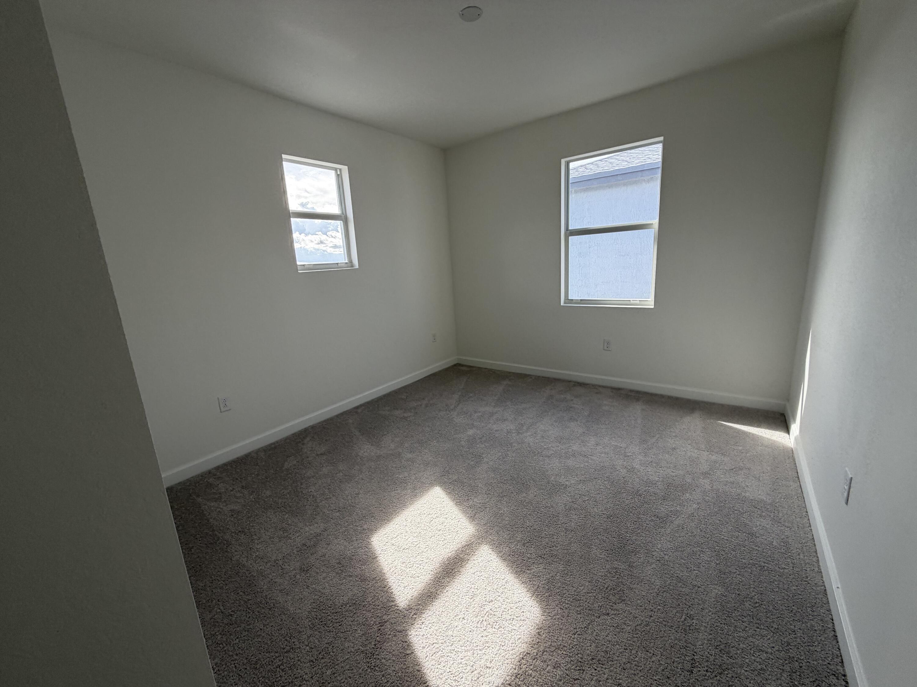 19407 Southwest 340th Street Homestead, FL 33034 - Photo 8 of 15 an empty room with windows