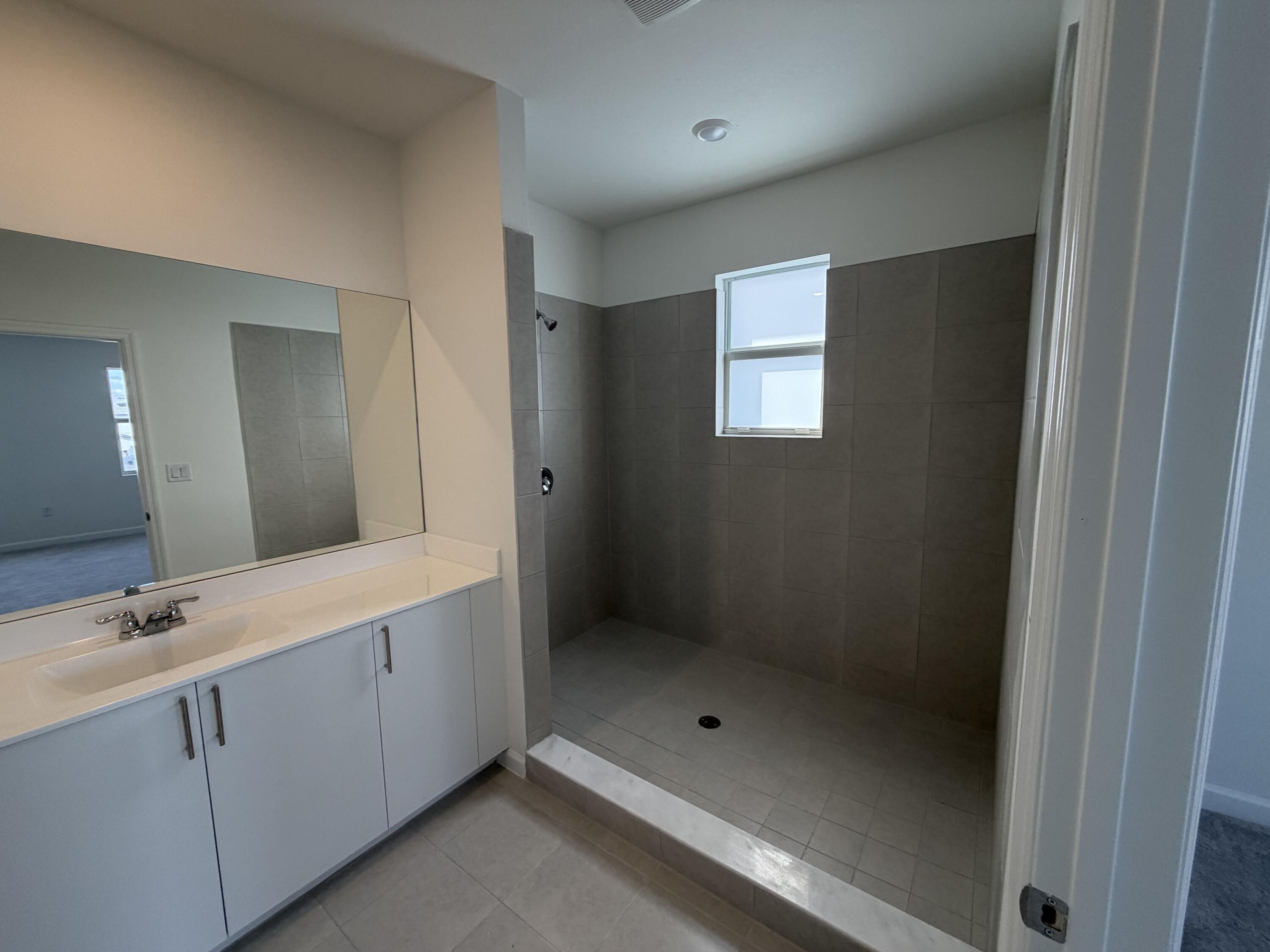 19407 Southwest 340th Street Homestead, FL 33034 - Photo 10 of 15 a bathroom with a shower and a sink