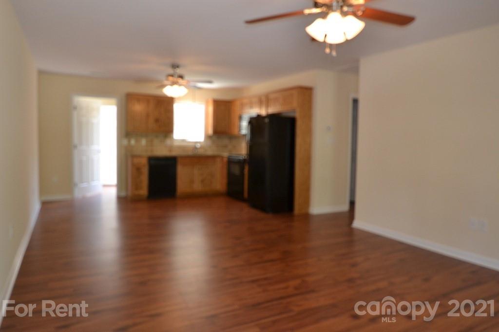 3793 Lee Moore Road, Unit 3793 Maiden, NC 28650 - Photo 2 of 11 a view of a kitchen with granite countertop wooden floor and a refrigerator