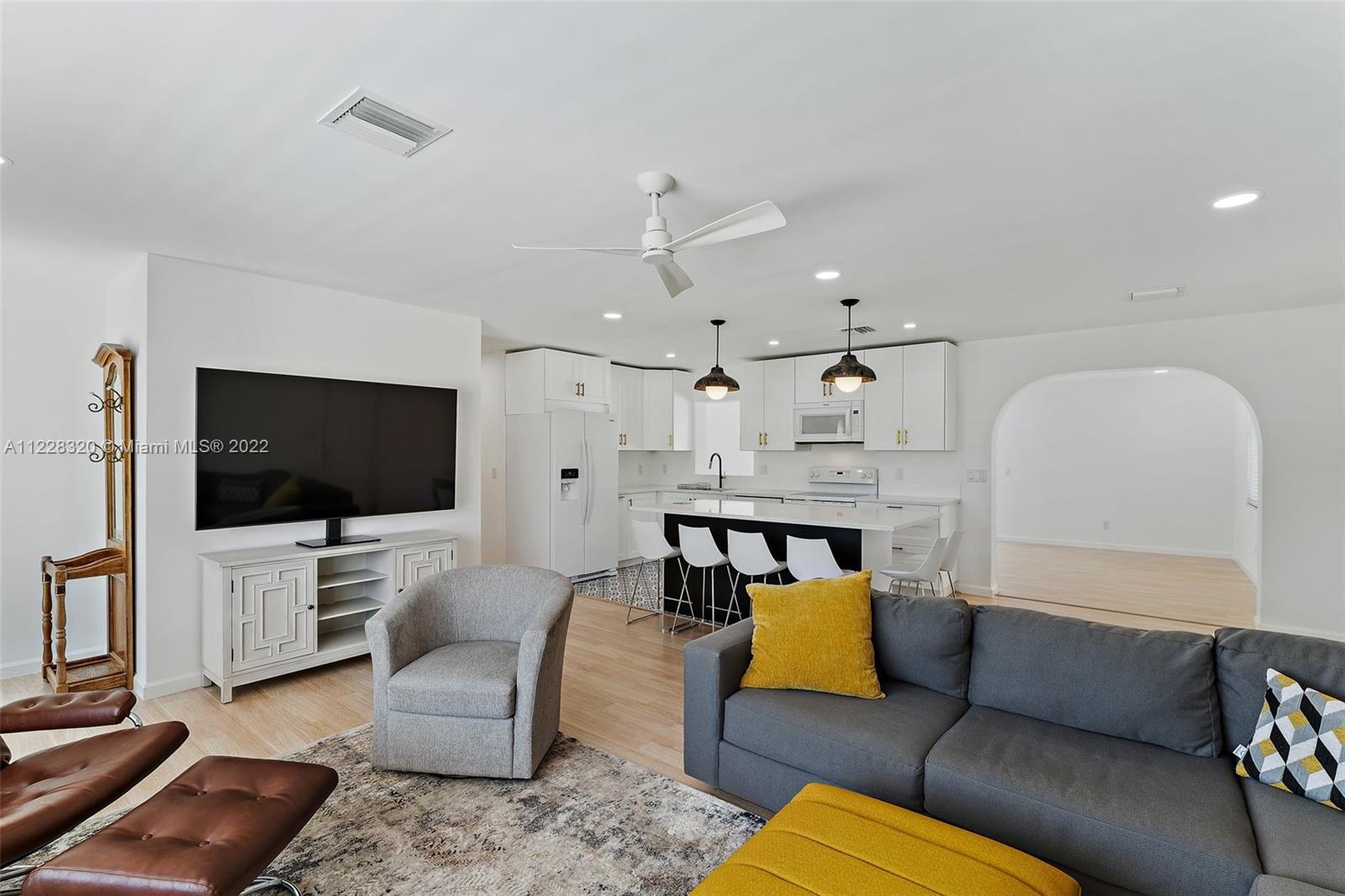 19 Shay Place Tequesta, FL 33469 - Photo 11 of 46 a living room with furniture and a flat screen tv