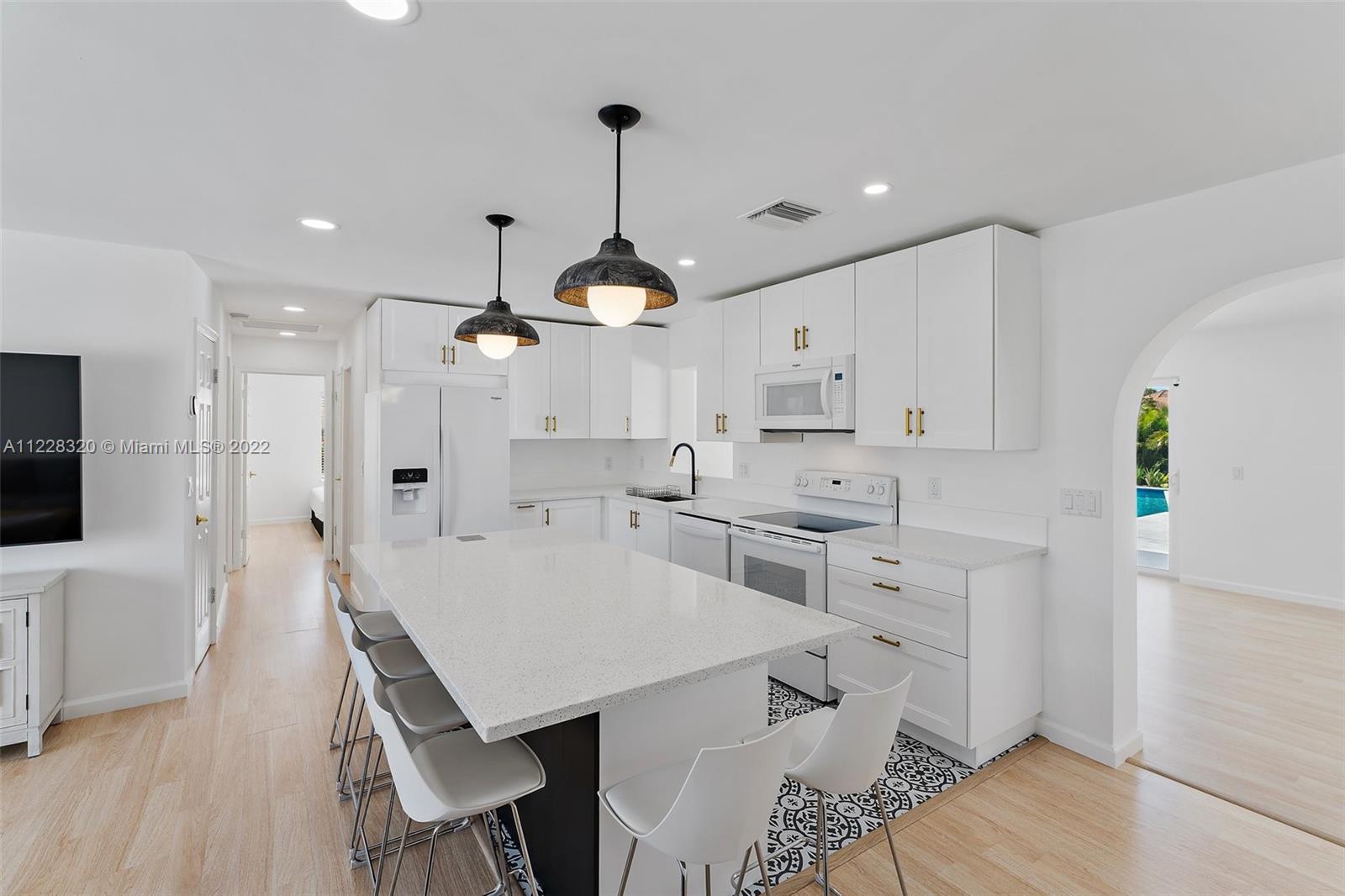 19 Shay Place Tequesta, FL 33469 - Photo 15 of 46 a large white kitchen with lots of counter space and refrigerator