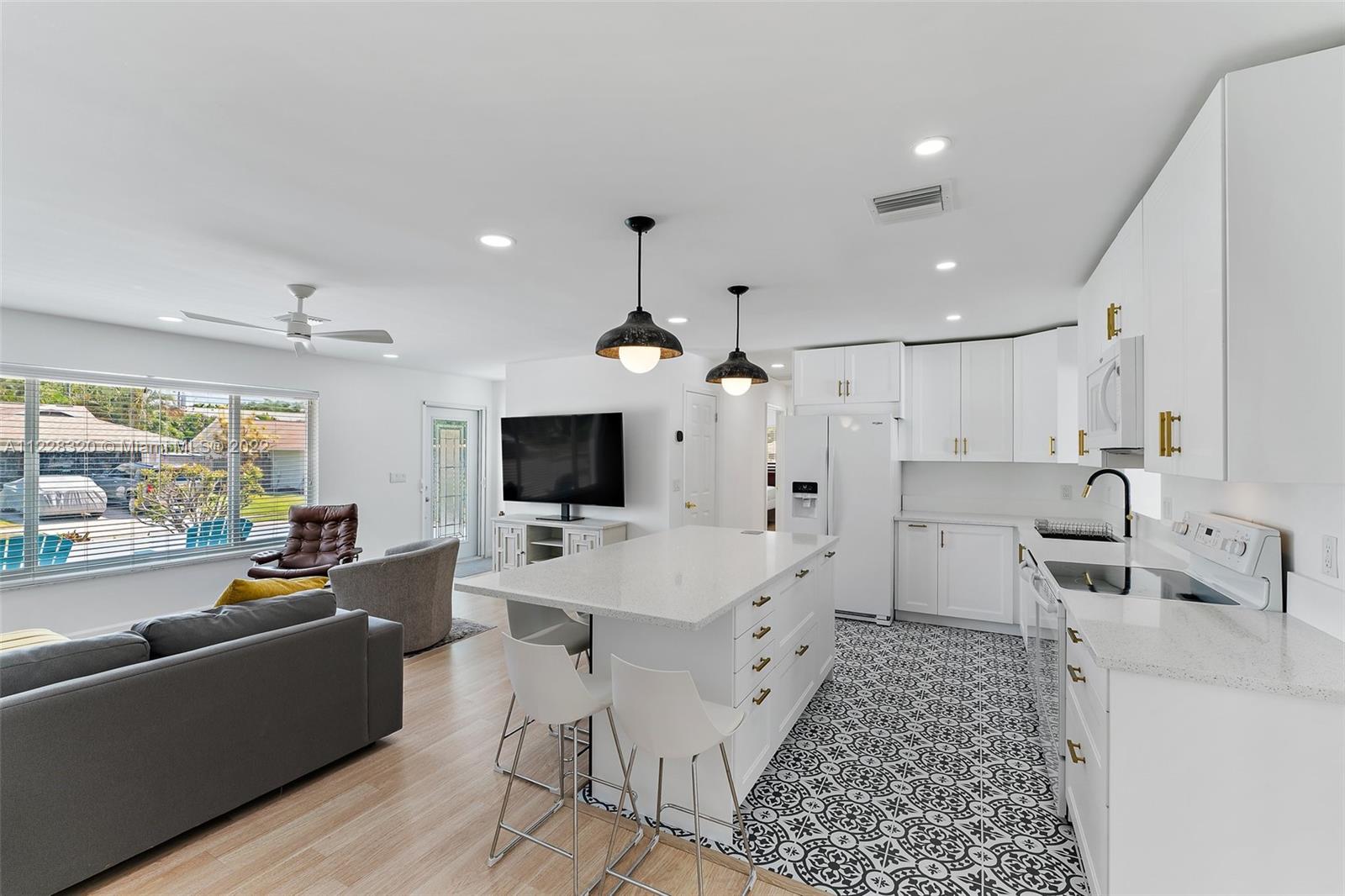 19 Shay Place Tequesta, FL 33469 - Photo 17 of 46 a large white kitchen with a large window and stainless steel appliances