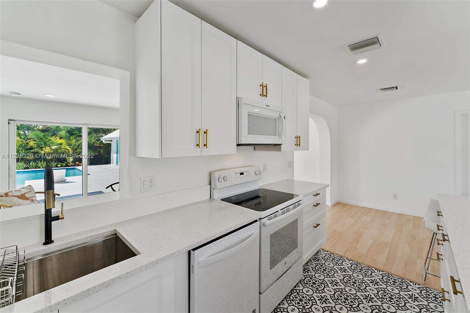 19 Shay Place Tequesta, FL 33469 - Photo 19 of 46 a kitchen that has a sink and a stove in it