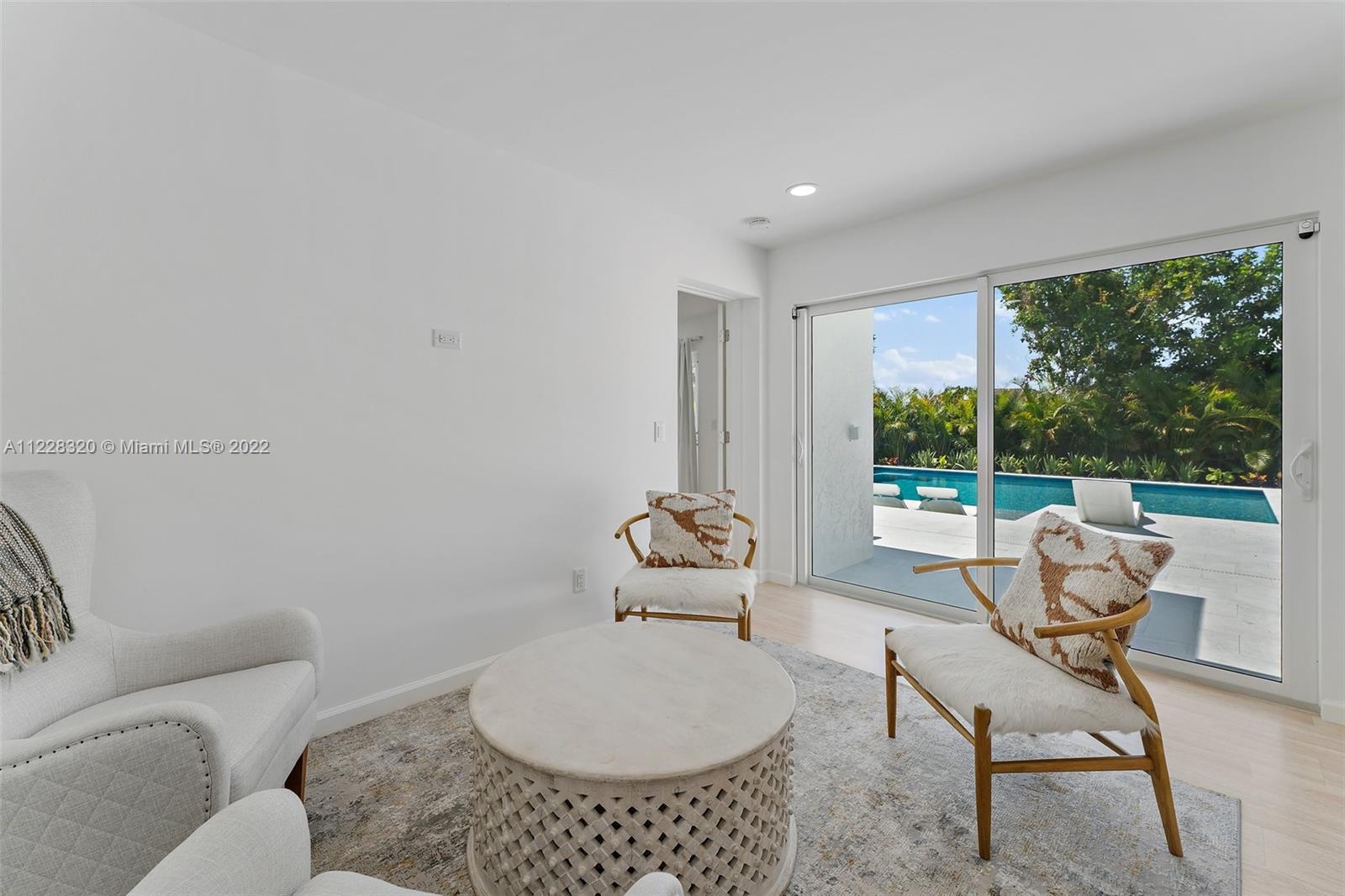 19 Shay Place Tequesta, FL 33469 - Photo 21 of 46 a living room with furniture and a floor to ceiling window