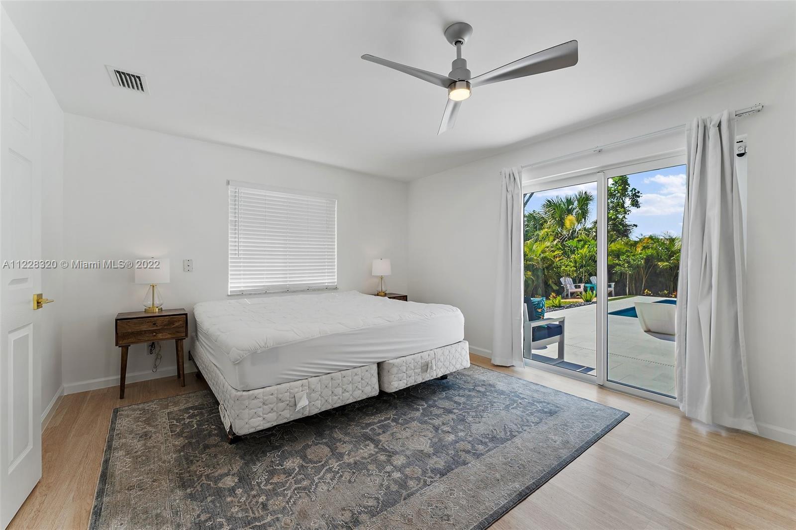 19 Shay Place Tequesta, FL 33469 - Photo 24 of 46 a bedroom with a bed a couch and a window