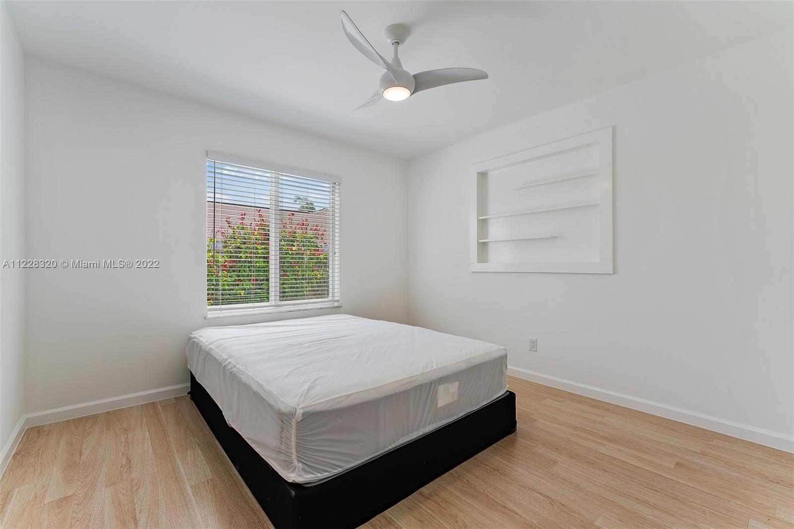 19 Shay Place Tequesta, FL 33469 - Photo 32 of 46 a bed sitting in a bedroom next to a window