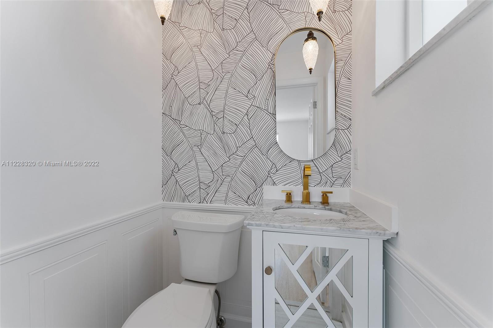 19 Shay Place Tequesta, FL 33469 - Photo 37 of 46 a bathroom with a toilet sink and mirror