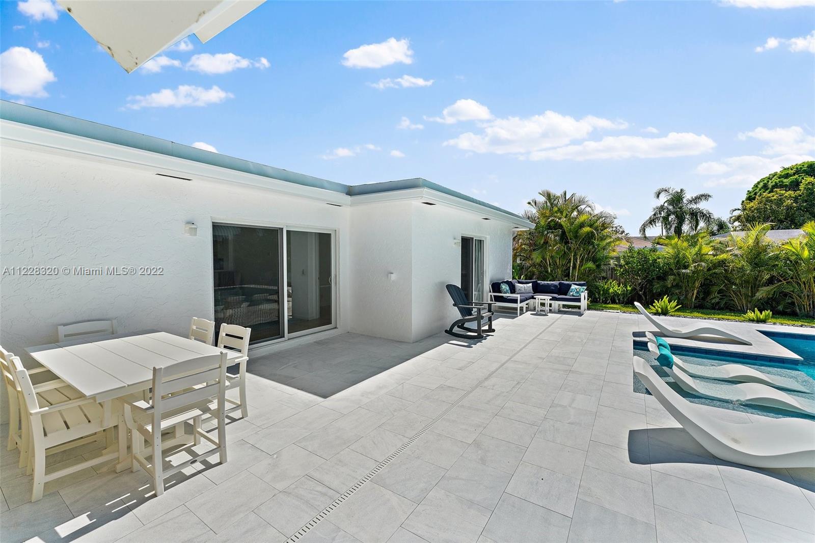 19 Shay Place Tequesta, FL 33469 - Photo 40 of 46 a swimming pool with outdoor seating and yard