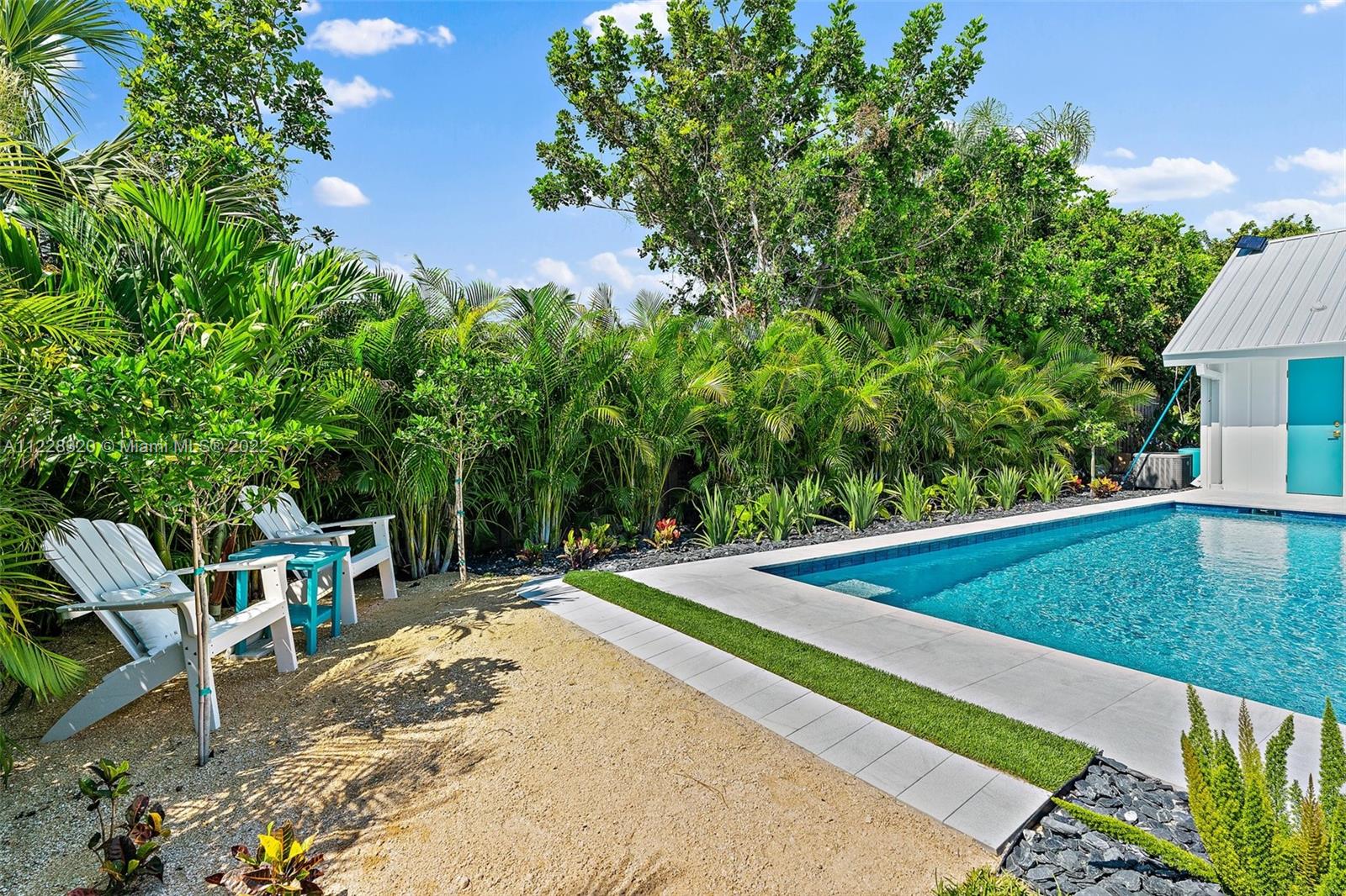19 Shay Place Tequesta, FL 33469 - Photo 43 of 46 a view of a backyard with chairs